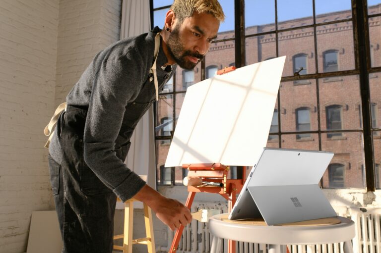 Artist Using Tablet While Working in Windowed Room