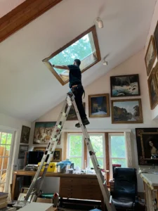Tint USA technician installing window film in a home